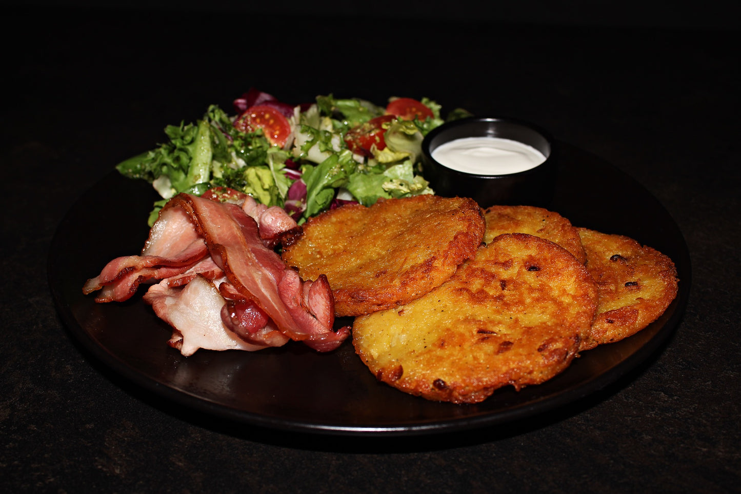 Potato pancakes with bacon and sour cream