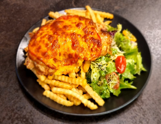 Pork chop with bacon and tomatoes, french fries and green salad