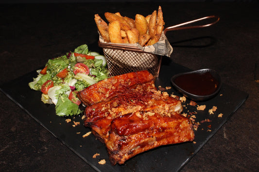Pork ribs in Jack Daniels glaze with salad, side dishes and sauce of choice