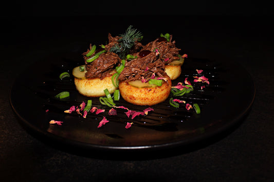 Cottage cheese pancakes with tomato-based grated beef, pickles and herbs