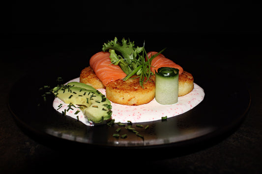 Cottage cheese pancakes with salmon, caviar cream sauce and avocado