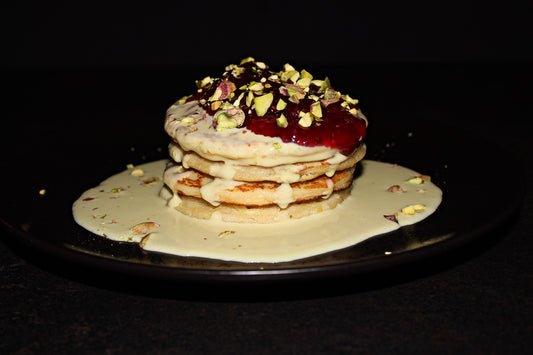 American pancakes with pistachio cream and raspberry sauce