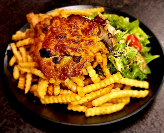 Pork chop with mushrooms, french fries and green salad