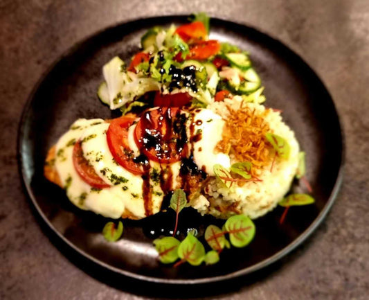 Chicken fillet chop with mozzarella cheese and tomatoes, with mushroom risotto and vegetable salad with basil pesto sauce