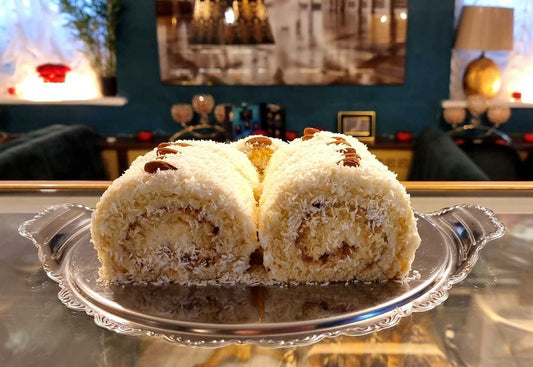 Raffaello roulette with boiled cream and almonds